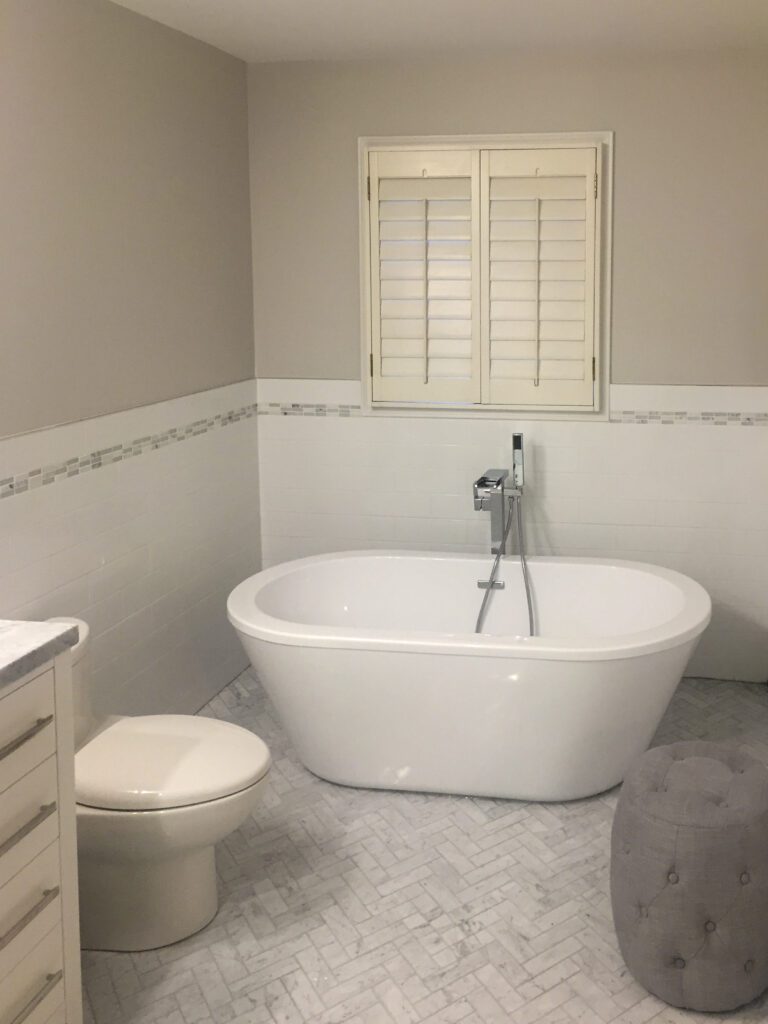 Custom bathroom design featuring a luxurious tub and tiles. 